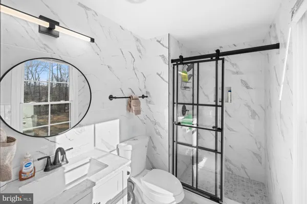 a bathroom with a toilet tub and shower