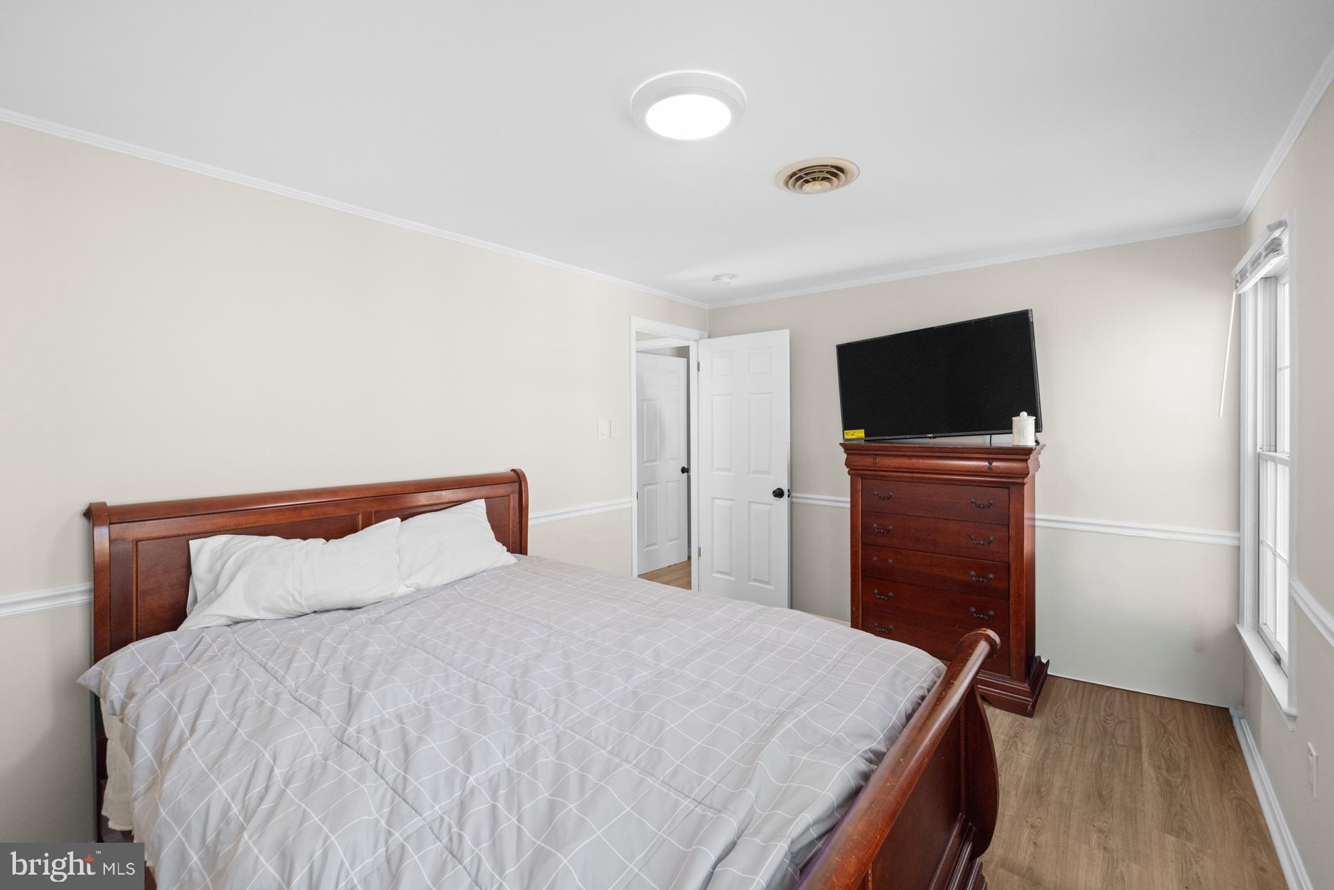 2907 Accokeek Road West Accokeek, MD 20607 - Photo 33 of 42 a bedroom with a bed and a flat screen tv