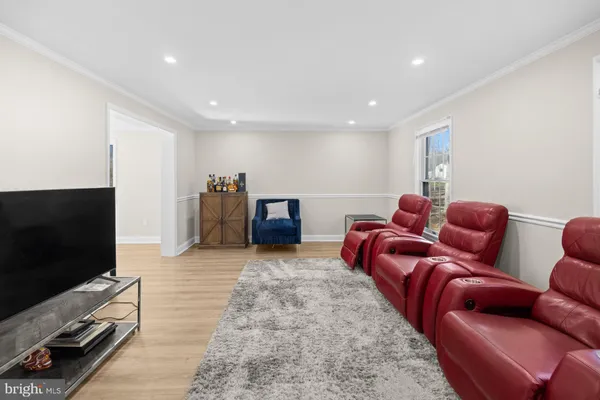 a living room with furniture a wooden floor and a large window