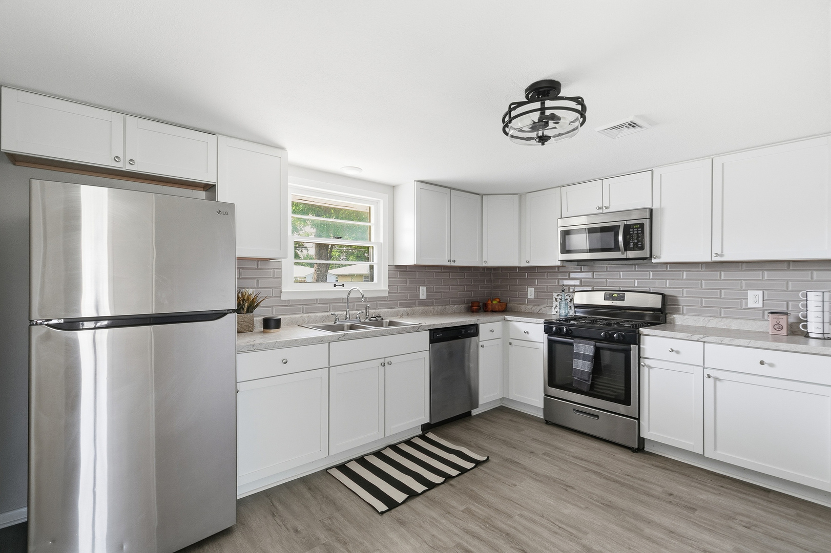 2306 9th Street Silvis, IL 61282 - Photo 12 of 32 a kitchen with stainless steel appliances a refrigerator sink and stove