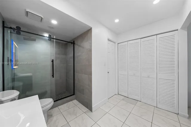 a bathroom with a shower and a toilet