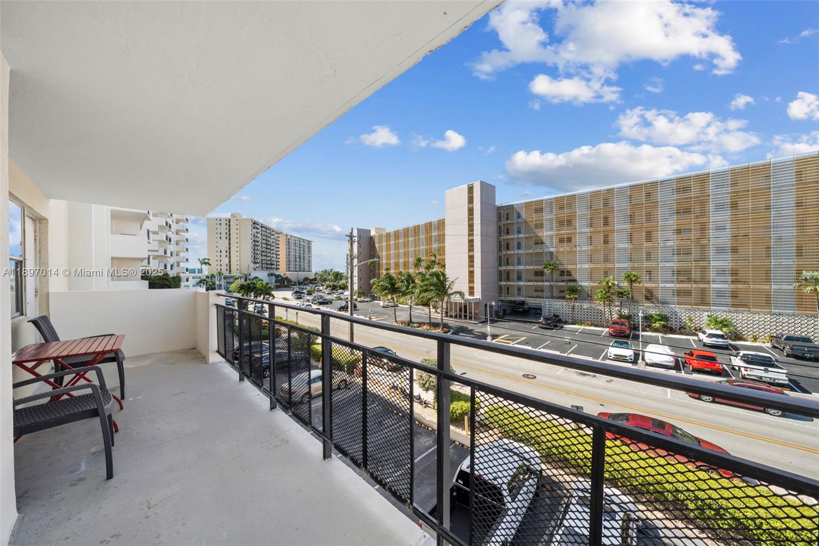 401 Golden Isles Drive, Unit 304 Hallandale Beach, FL 33009 - Photo 21 of 43 a city view with chairs and table in a balcony