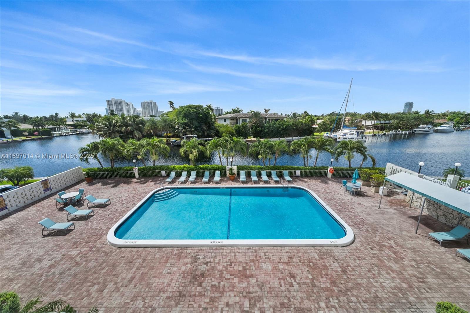401 Golden Isles Drive, Unit 304 Hallandale Beach, FL 33009 - Photo 26 of 43 a view of a swimming pool with a lake view
