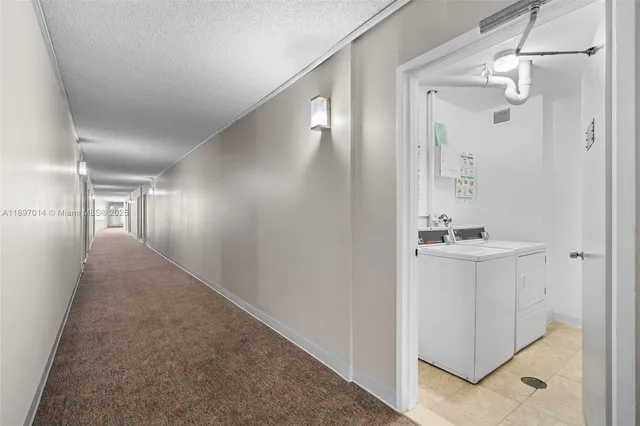 a view of a hallway with closet and wooden floor