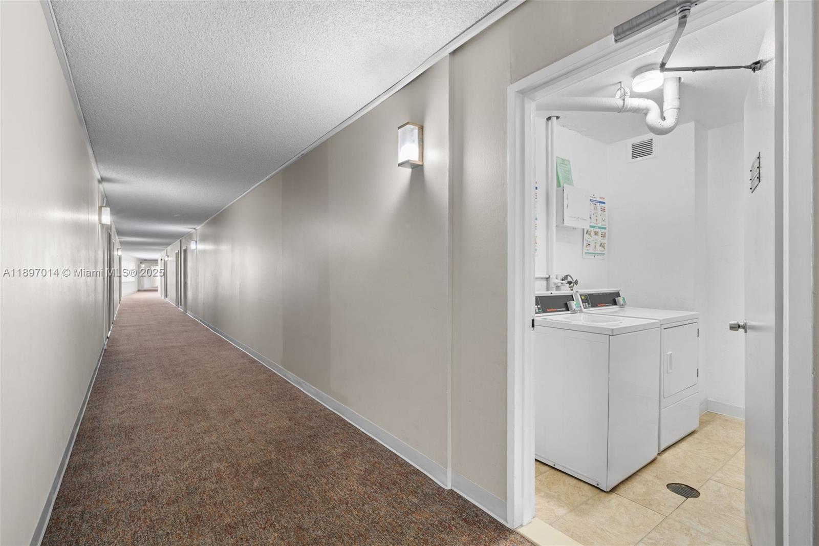 401 Golden Isles Drive, Unit 304 Hallandale Beach, FL 33009 - Photo 32 of 43 a view of a hallway with closet and wooden floor