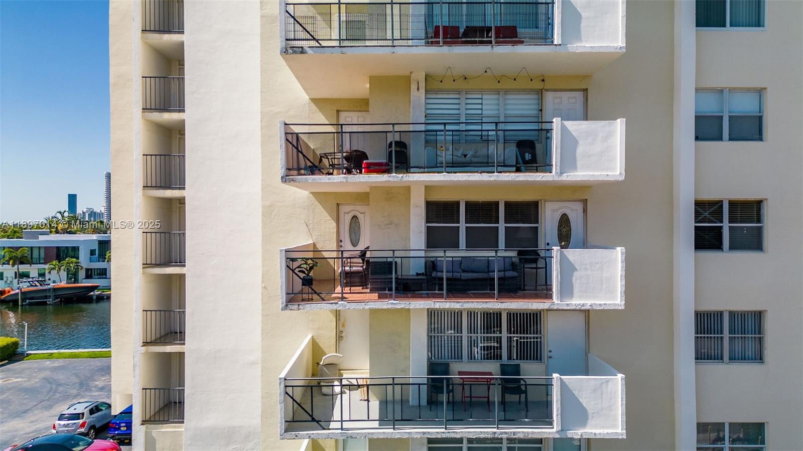 401 Golden Isles Drive, Unit 304 Hallandale Beach, FL 33009 - Photo 34 of 43 a front view of a building with glass windows and a table