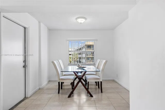 a view of a dining room with furniture and a window