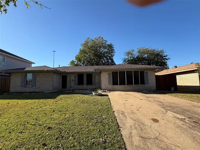 a house that has a big yard with large trees