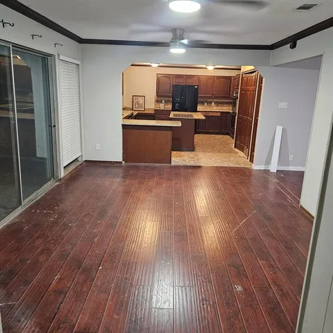 a view of living room with wooden floor and furniture