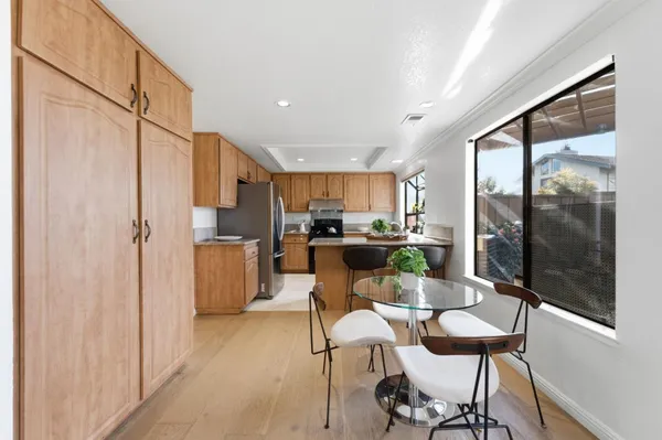 a kitchen with a refrigerator and a table chair