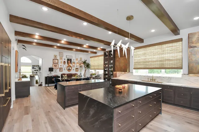 a kitchen with counter top space sink stove and cabinets