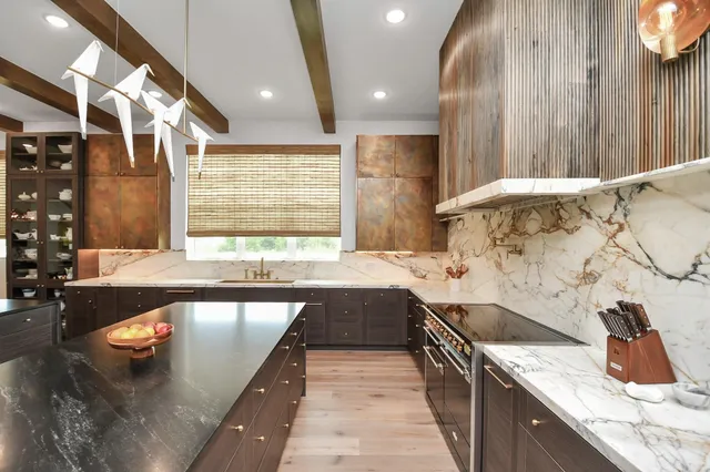 a kitchen with a sink and a stove top oven
