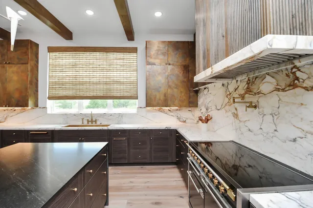 a kitchen with a sink and a stove top oven