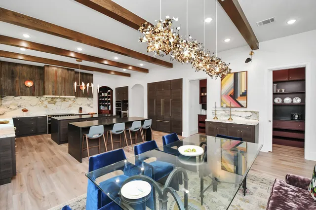 a large kitchen with a table and chairs