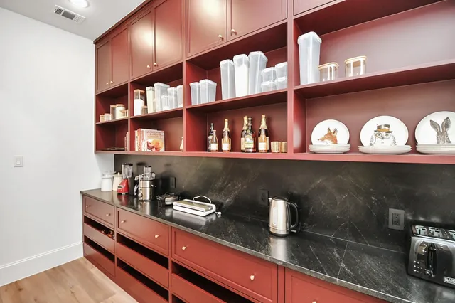 a kitchen with a sink and a shelf