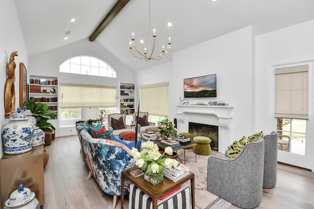 a living room with fireplace furniture and a fireplace