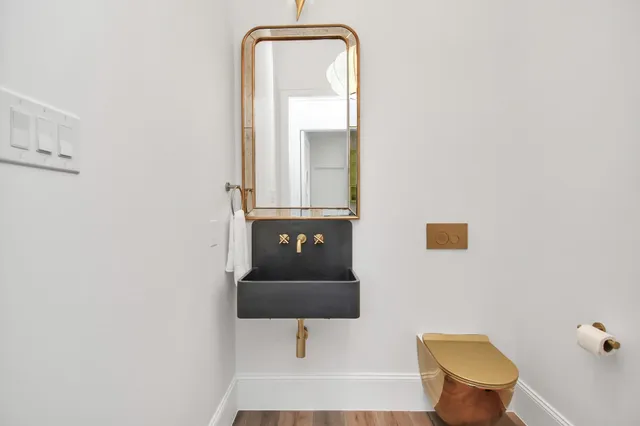 a bathroom with a toilet and a mirror
