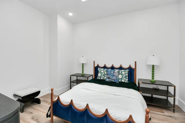 a bedroom with a bed and a chair