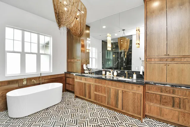 a bathroom with a large tub sink and window