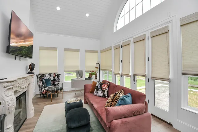 a living room with furniture a flat screen tv and a fireplace