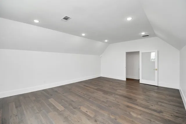 an empty room with wooden floor and closet