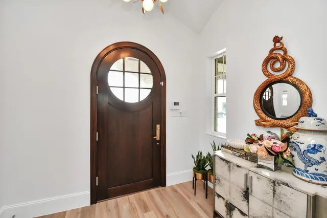 a view of a bedroom with washer and a mirror
