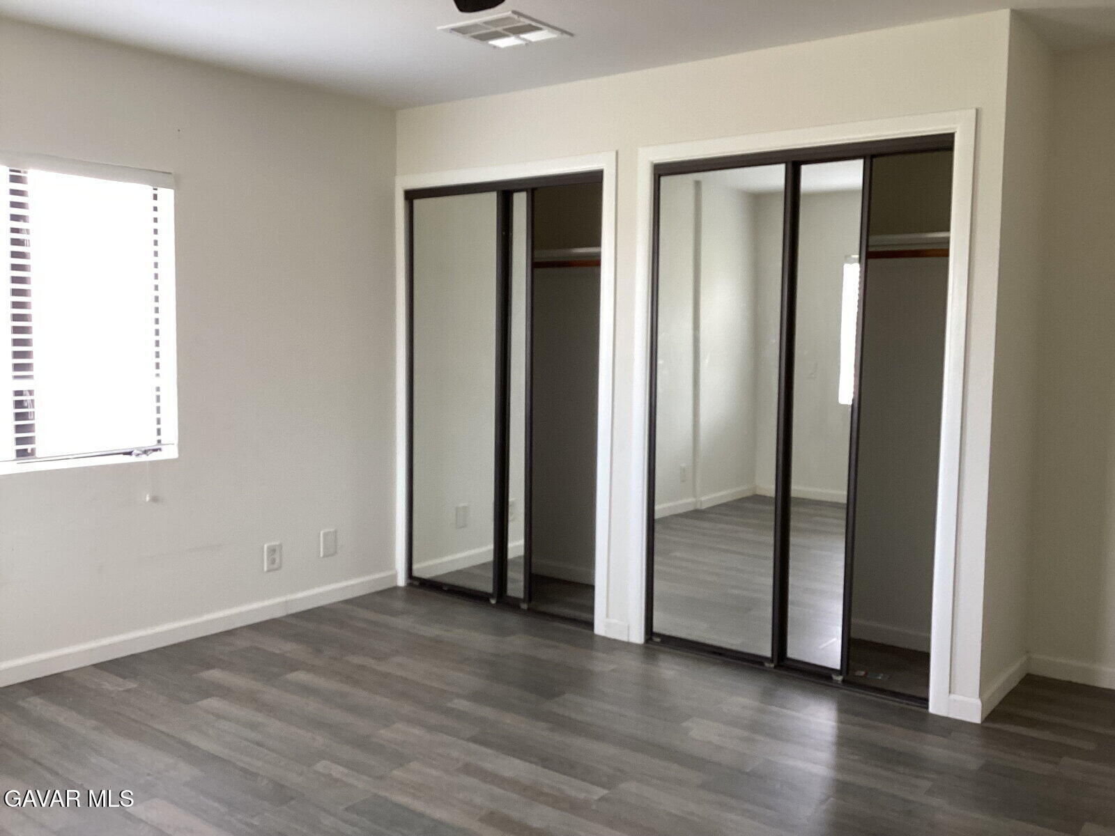 43324 45th Street West Lancaster, CA 93536 - Photo 7 of 10 an empty room with wooden floor and closet
