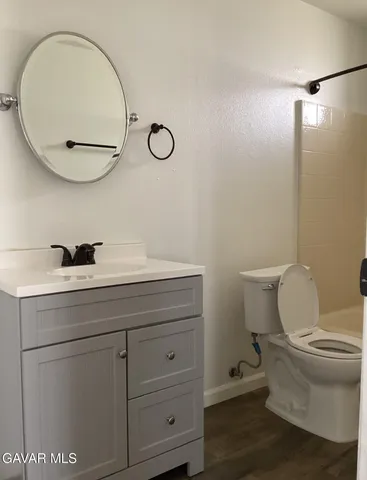 a bathroom with a sink mirror and toilet