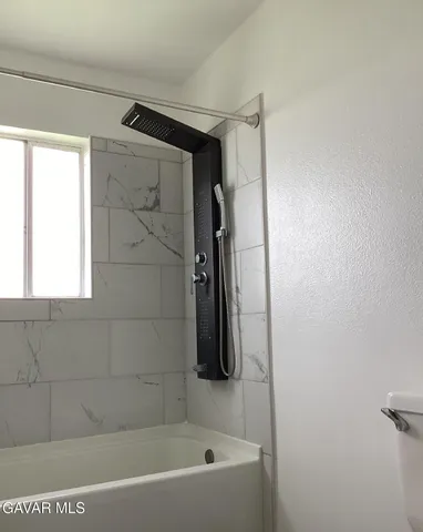 a bathroom with a shower and a bathtub
