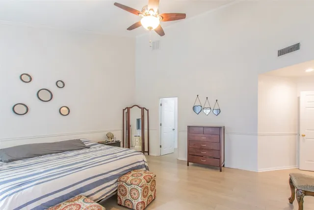 a bedroom with a bed dresser and a window