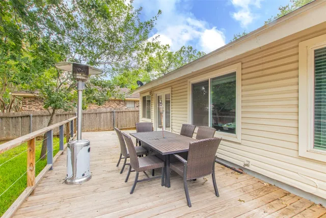 a view of a deck with furniture and trees
