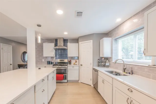 a kitchen with stainless steel appliances kitchen island granite countertop a sink and cabinets