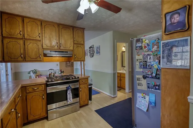 a kitchen with stainless steel appliances granite countertop a stove and a refrigerator