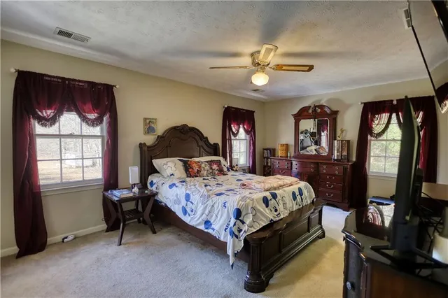 a bed sitting in a bedroom next to a window