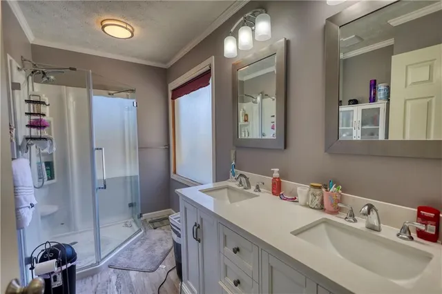 a bathroom with a sink double vanity and a mirror