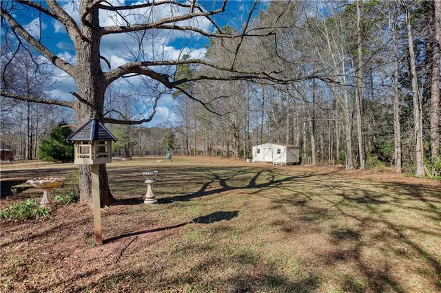 a view of a yard with wooden fence