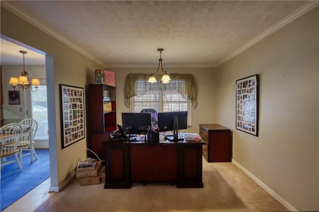 a view of a workspace with furniture and wooden floor