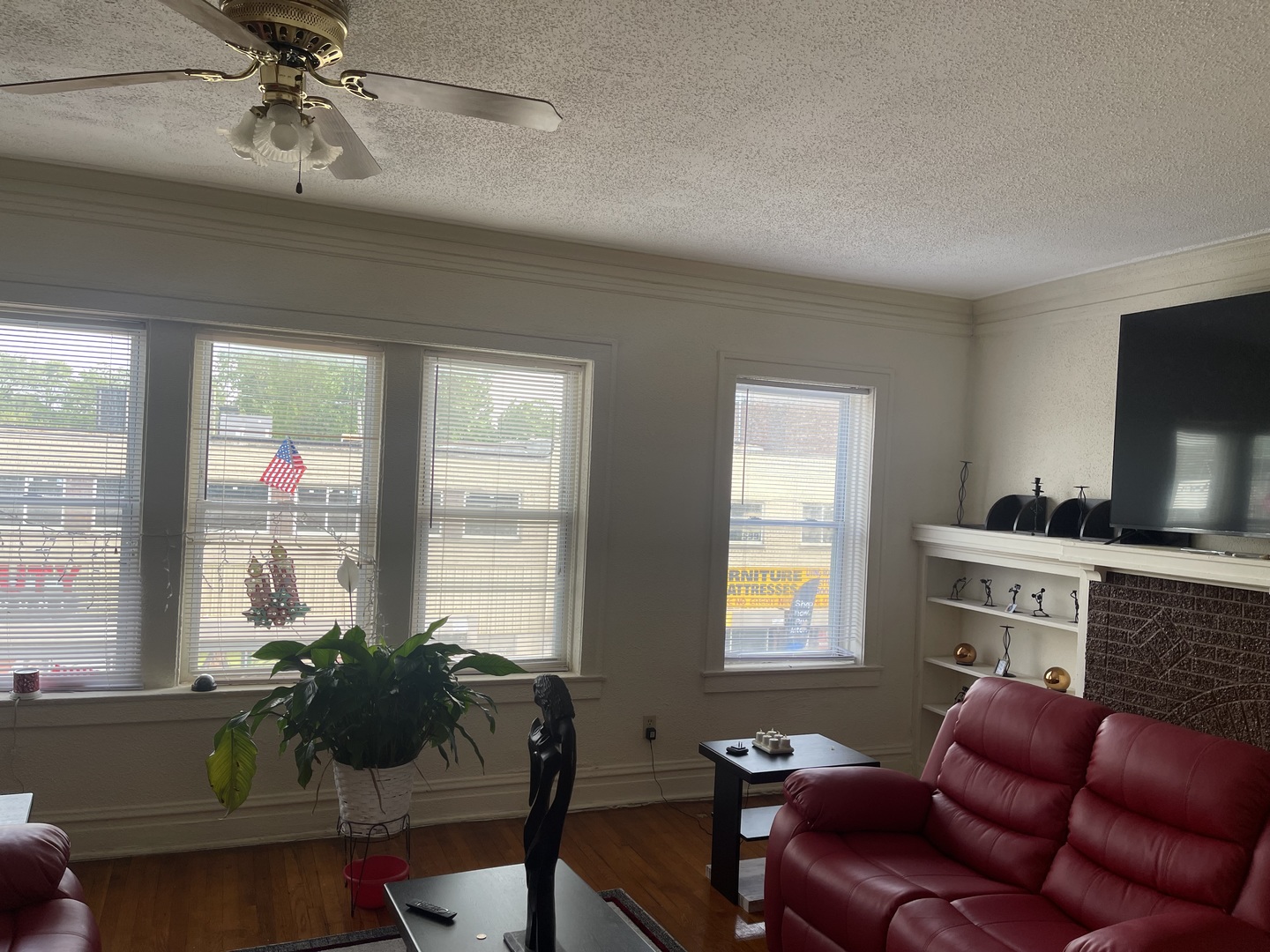 1013 West 63rd Street Chicago, IL 60621 - Photo 10 of 16 a living room with furniture and a flat screen tv