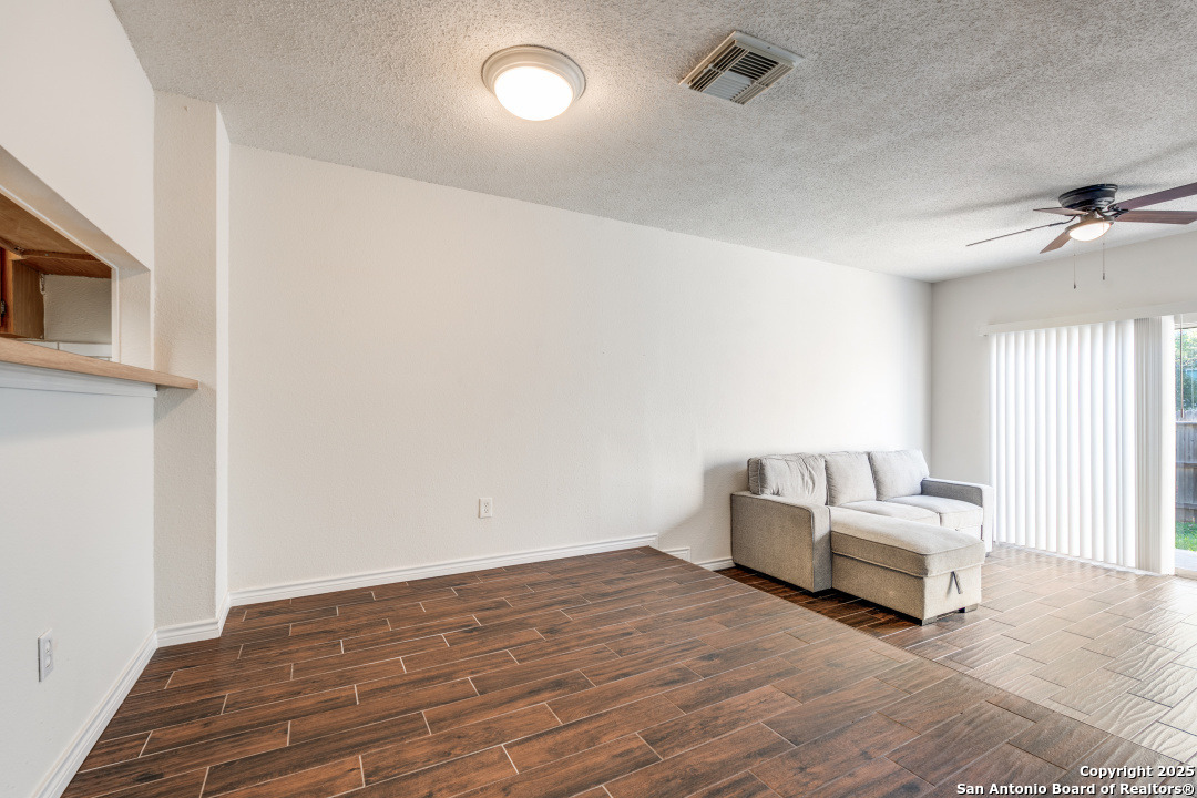 10254 Dover Ridge, Unit 204 San Antonio, TX 78250 - Photo 14 of 31 a living room with furniture and a fireplace