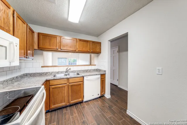 a kitchen with stainless steel appliances granite countertop a stove and a sink