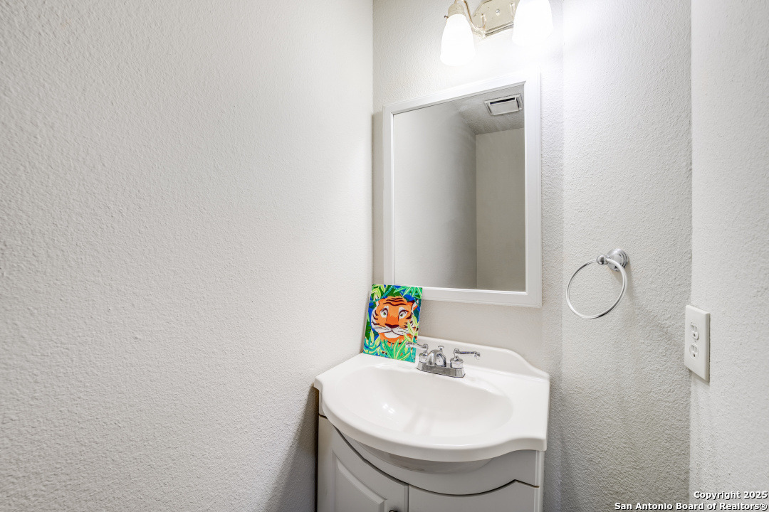 10254 Dover Ridge, Unit 204 San Antonio, TX 78250 - Photo 19 of 31 a bathroom with a sink toilet and a mirror