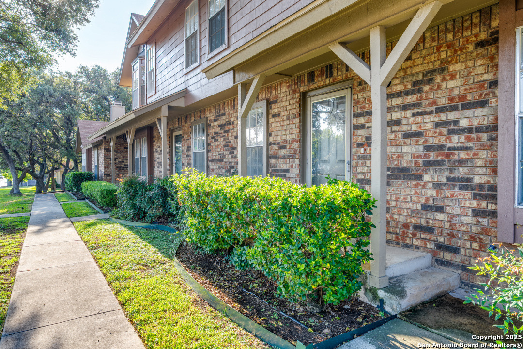 10254 Dover Ridge, Unit 204 San Antonio, TX 78250 - Photo 2 of 31 a front view of a house with garden