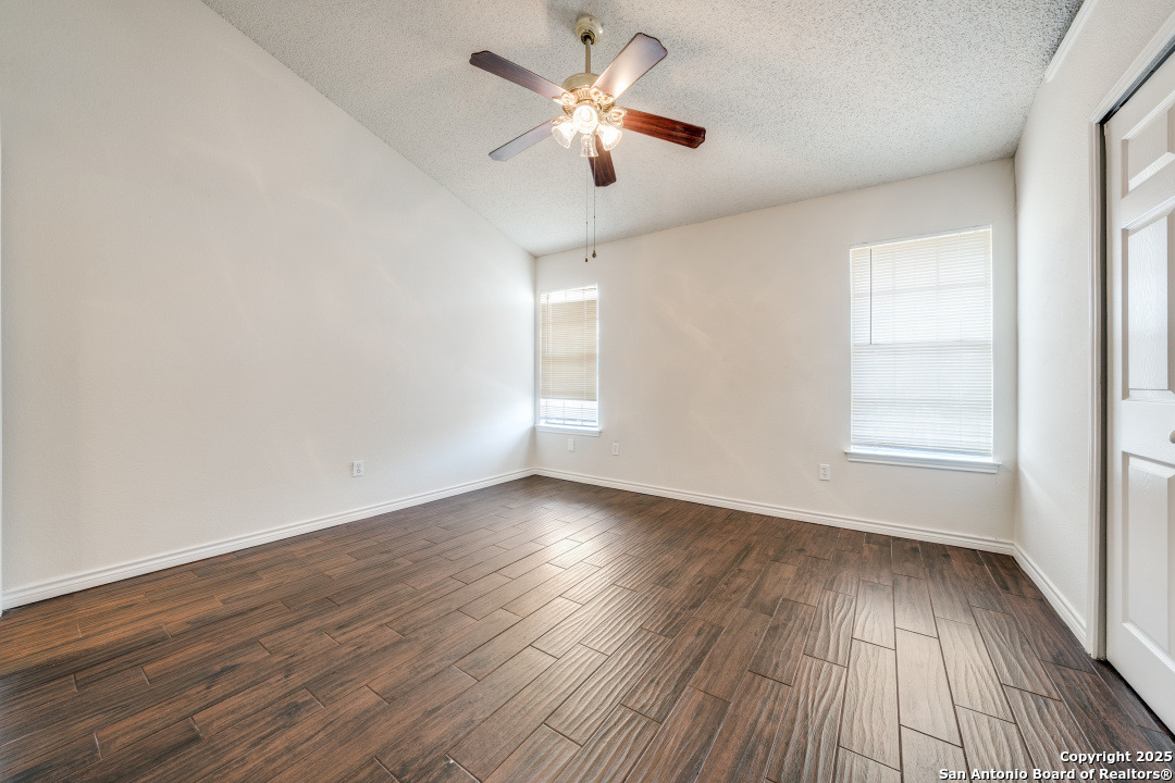 10254 Dover Ridge, Unit 204 San Antonio, TX 78250 - Photo 23 of 31 an empty room with wooden floor and windows