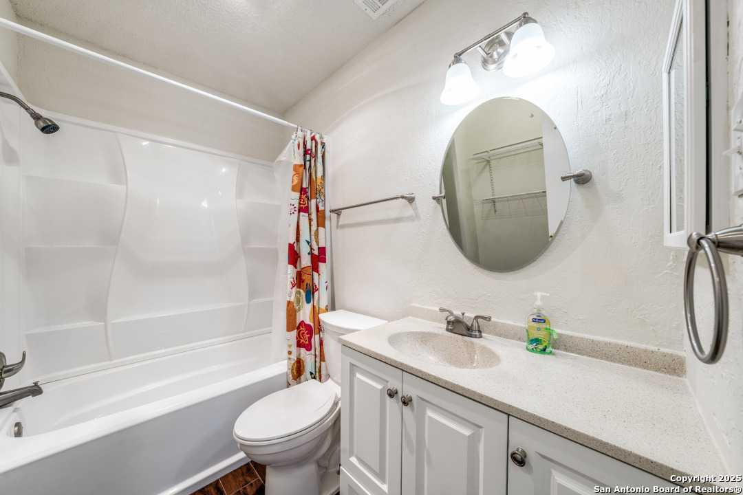 10254 Dover Ridge, Unit 204 San Antonio, TX 78250 - Photo 24 of 31 a bathroom with a sink a toilet and a mirror