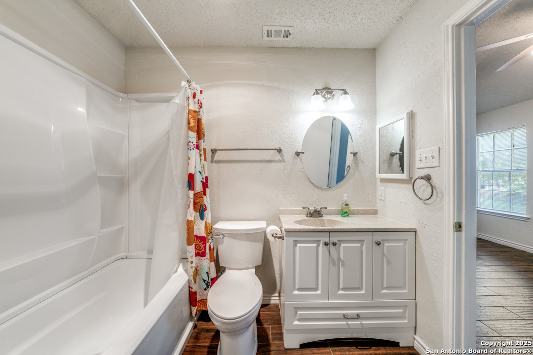 10254 Dover Ridge, Unit 204 San Antonio, TX 78250 - Photo 25 of 31 a bathroom with a sink vanity mirror and toilet