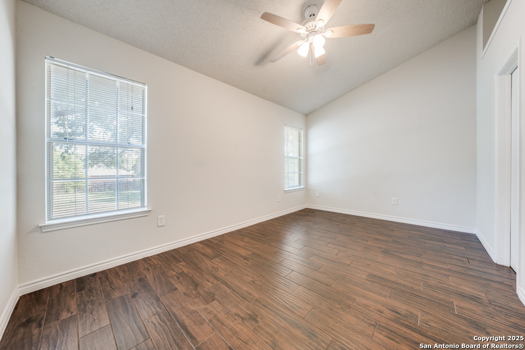 10254 Dover Ridge, Unit 204 San Antonio, TX 78250 - Photo 26 of 31 a view of empty room with wooden floor and fan