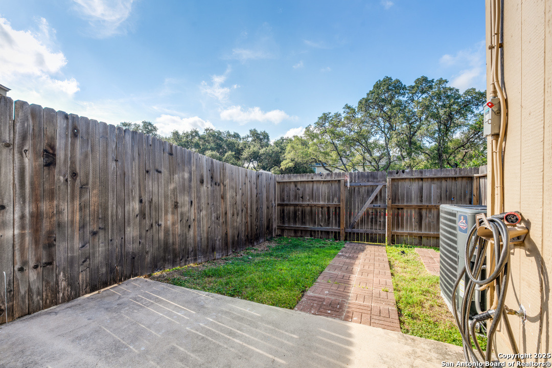 10254 Dover Ridge, Unit 204 San Antonio, TX 78250 - Photo 27 of 31 a view of a backyard with wooden fence