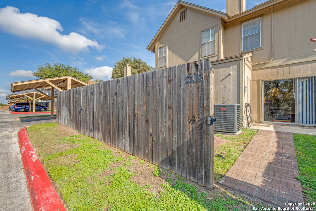 10254 Dover Ridge, Unit 204 San Antonio, TX 78250 - Photo 30 of 31 a view of a backyard with pathway