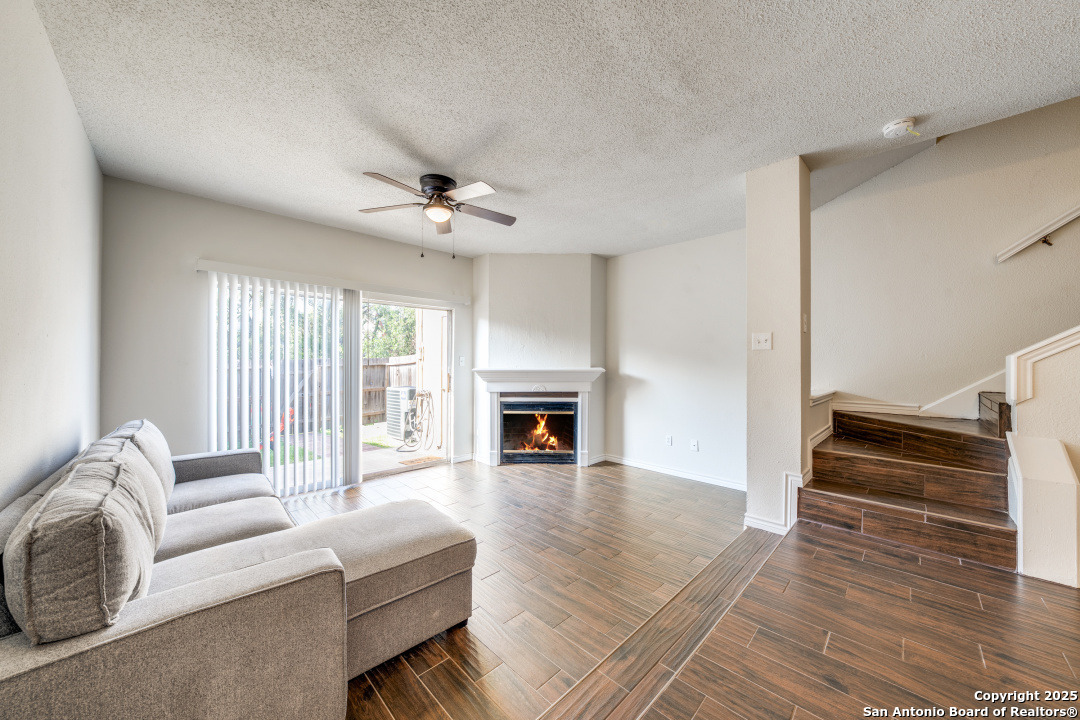 10254 Dover Ridge, Unit 204 San Antonio, TX 78250 - Photo 5 of 31 a living room with furniture fireplace and flat screen tv