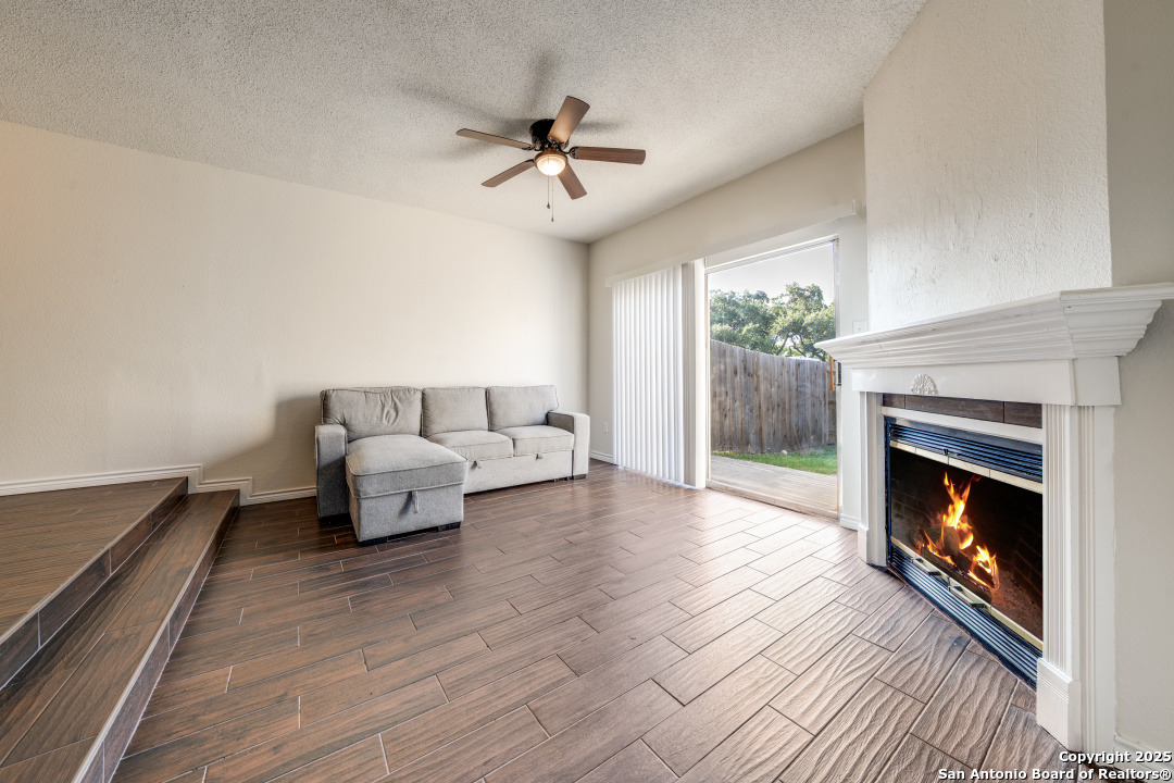 10254 Dover Ridge, Unit 204 San Antonio, TX 78250 - Photo 7 of 31 a living room with furniture and a fireplace